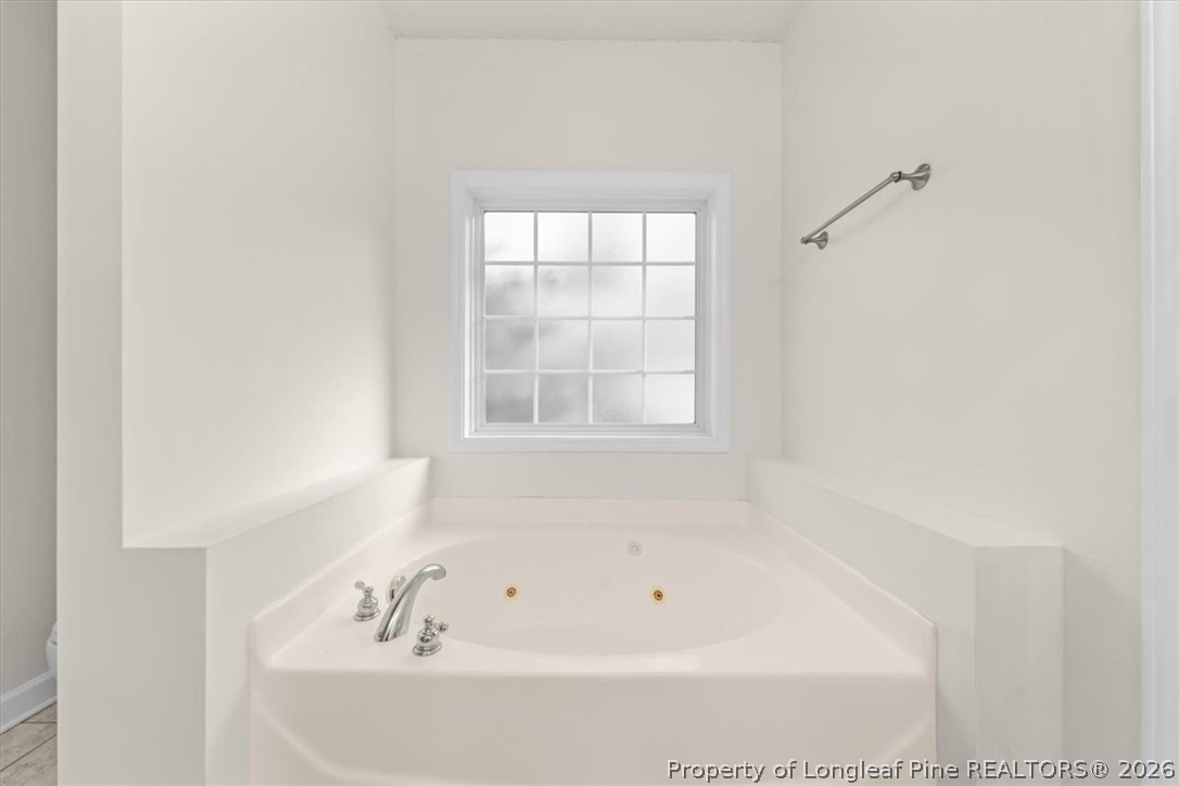 60 Spring Lake Drive Pinehurst, NC 28374 - Photo 19 of 42 a white bath tub sitting next to a window
