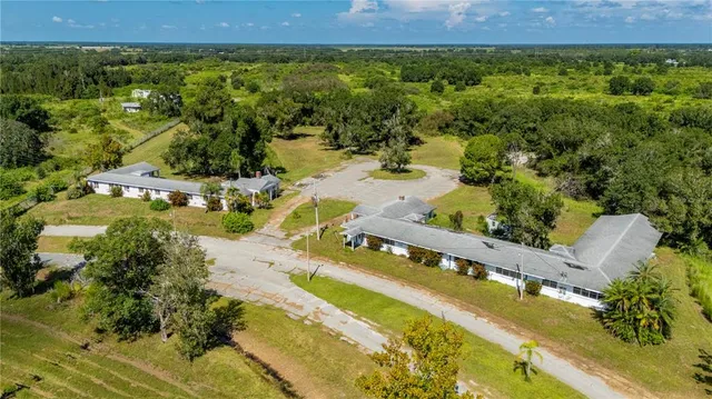 an aerial view of residential houses with outdoor space