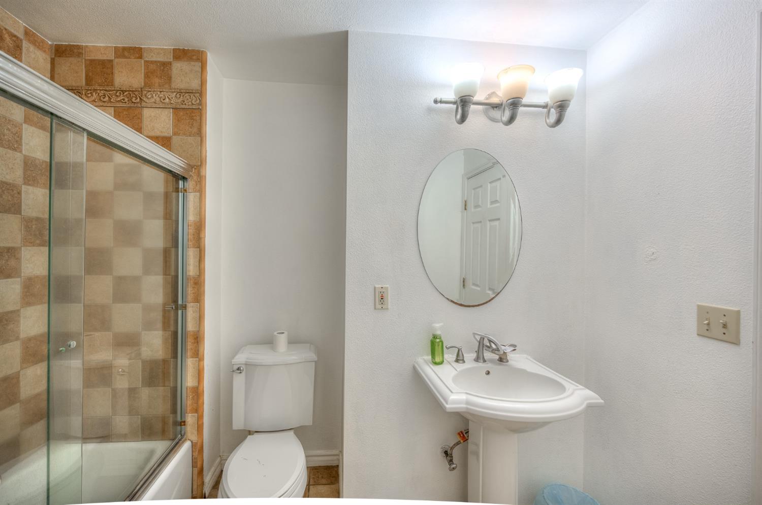 2170 Moir Drive Sanger, CA 93657 - Photo 12 of 22 a bathroom with a sink a toilet and shower