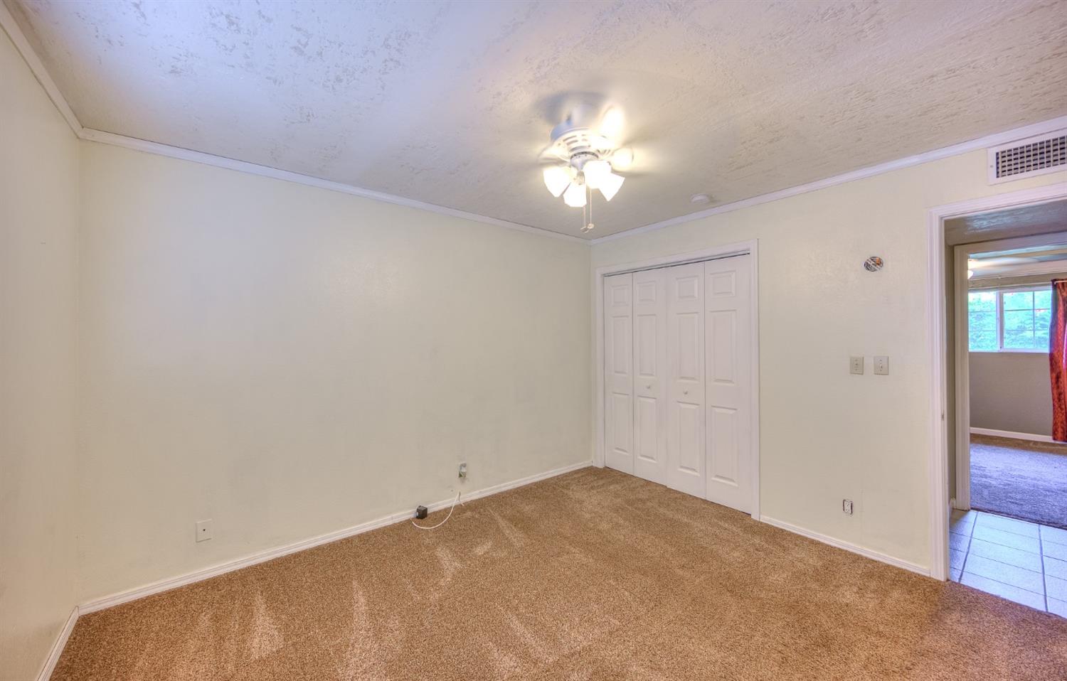 2170 Moir Drive Sanger, CA 93657 - Photo 16 of 22 an empty room with a chandelier fan