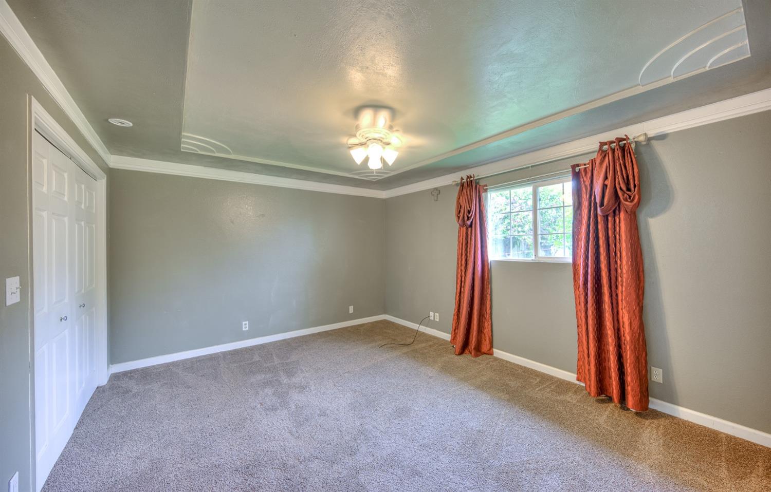 2170 Moir Drive Sanger, CA 93657 - Photo 18 of 22 an empty room with windows and chandelier