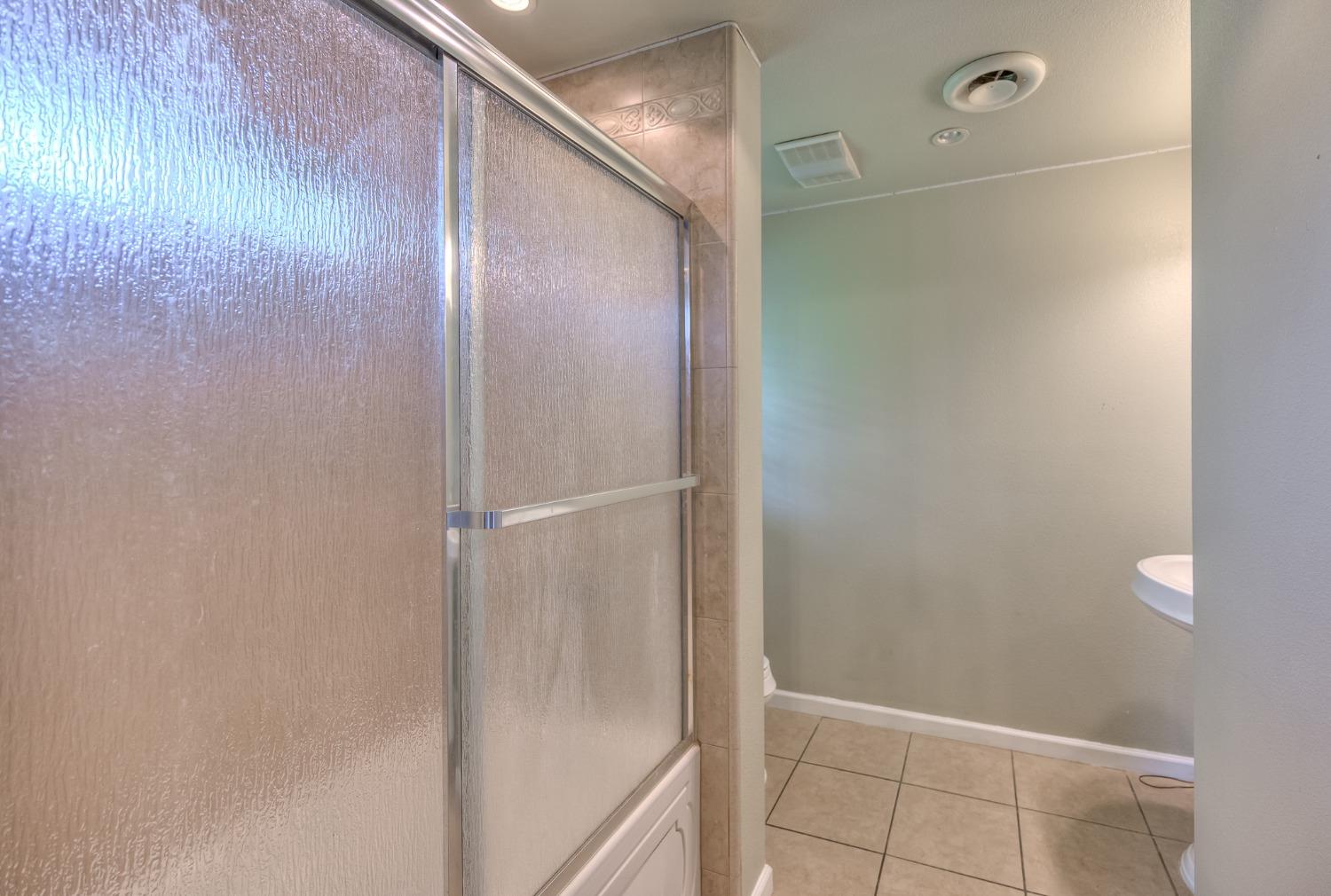2170 Moir Drive Sanger, CA 93657 - Photo 19 of 22 a bathroom with a glass shower door