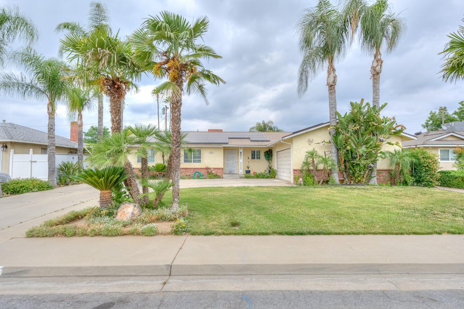 2170 Moir Drive Sanger, CA 93657 - Photo 2 of 22 a front view of a house with a garden and a yard