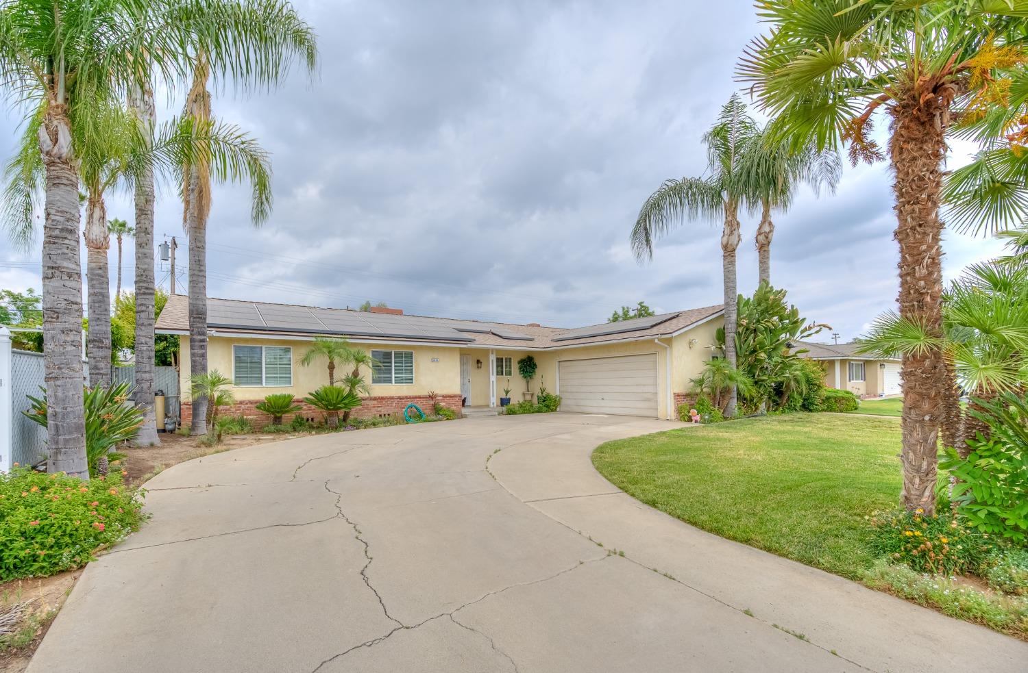 2170 Moir Drive Sanger, CA 93657 - Photo 3 of 22 a view of a house with a yard and palm trees