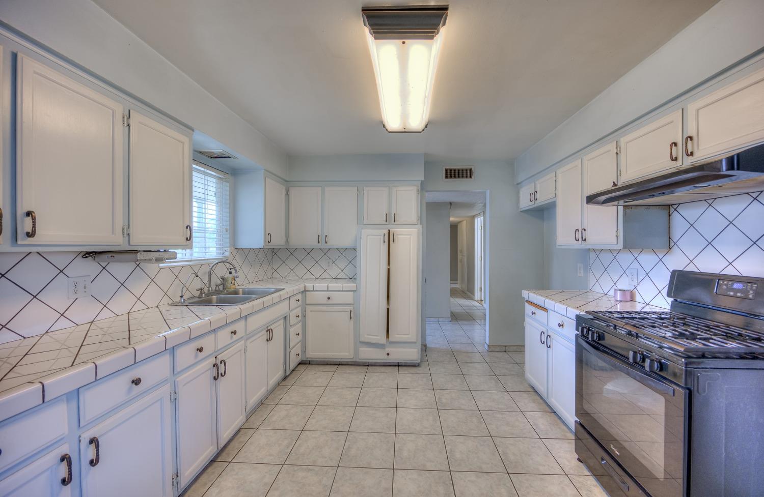 2170 Moir Drive Sanger, CA 93657 - Photo 5 of 22 a kitchen with stainless steel appliances granite countertop a sink and a stove