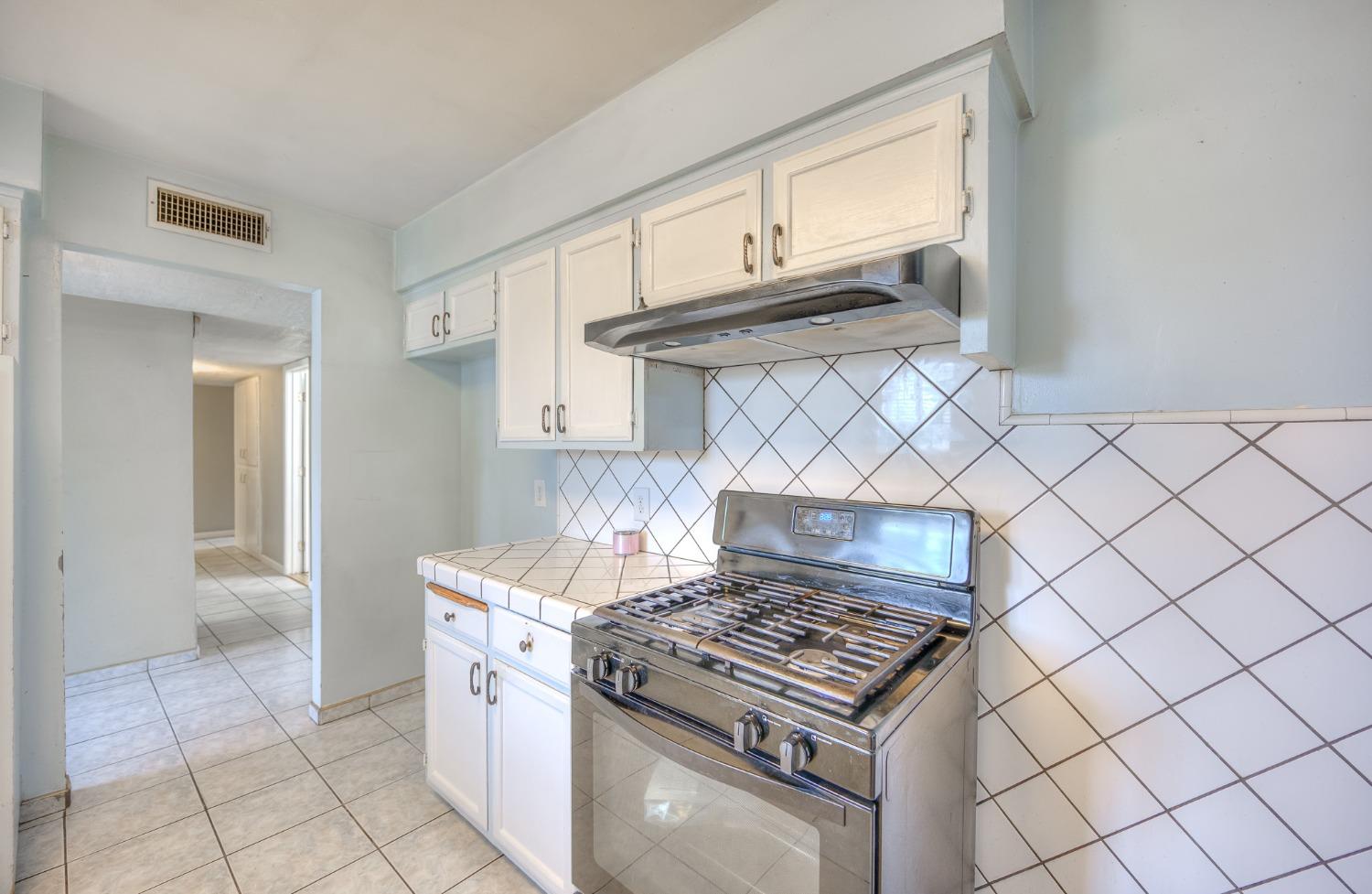 2170 Moir Drive Sanger, CA 93657 - Photo 7 of 22 a stove top oven sitting inside of a kitchen