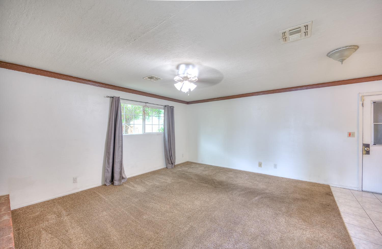2170 Moir Drive Sanger, CA 93657 - Photo 9 of 22 a view of a big room with windows and chandelier fan