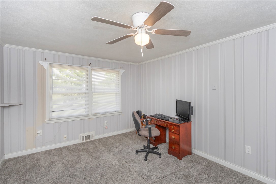 1218 Bolt Drive Anderson, SC 29621 - Photo 21 of 46 A well-lit room with plush carpeting and paneling offers a quiet space for productivity.