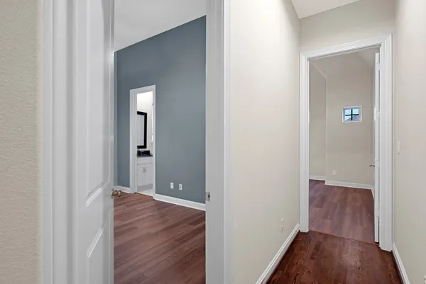a view of a hallway with wooden floor