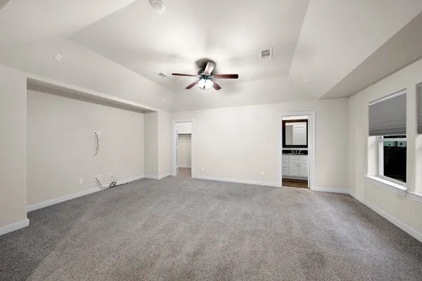 an empty room with closet and windows