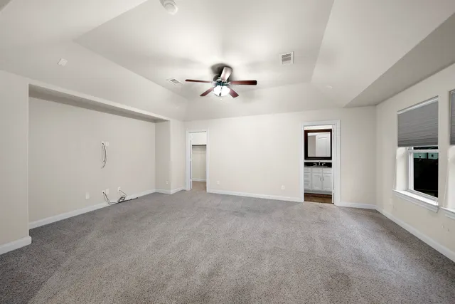 an empty room with closet and windows