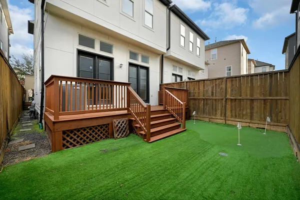 a view of a house with a yard and deck