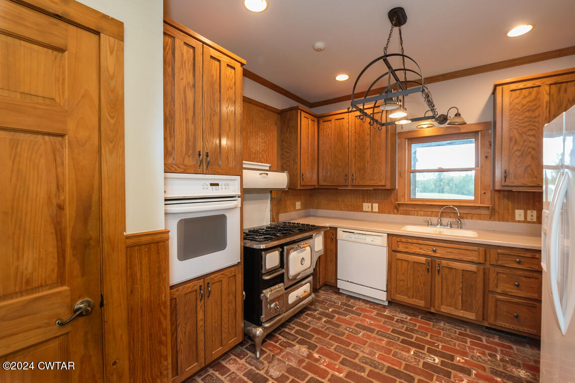 4392 Alberton Road Lexington, TN 38351 - Photo 20 of 75 a kitchen with a sink window and cabinets