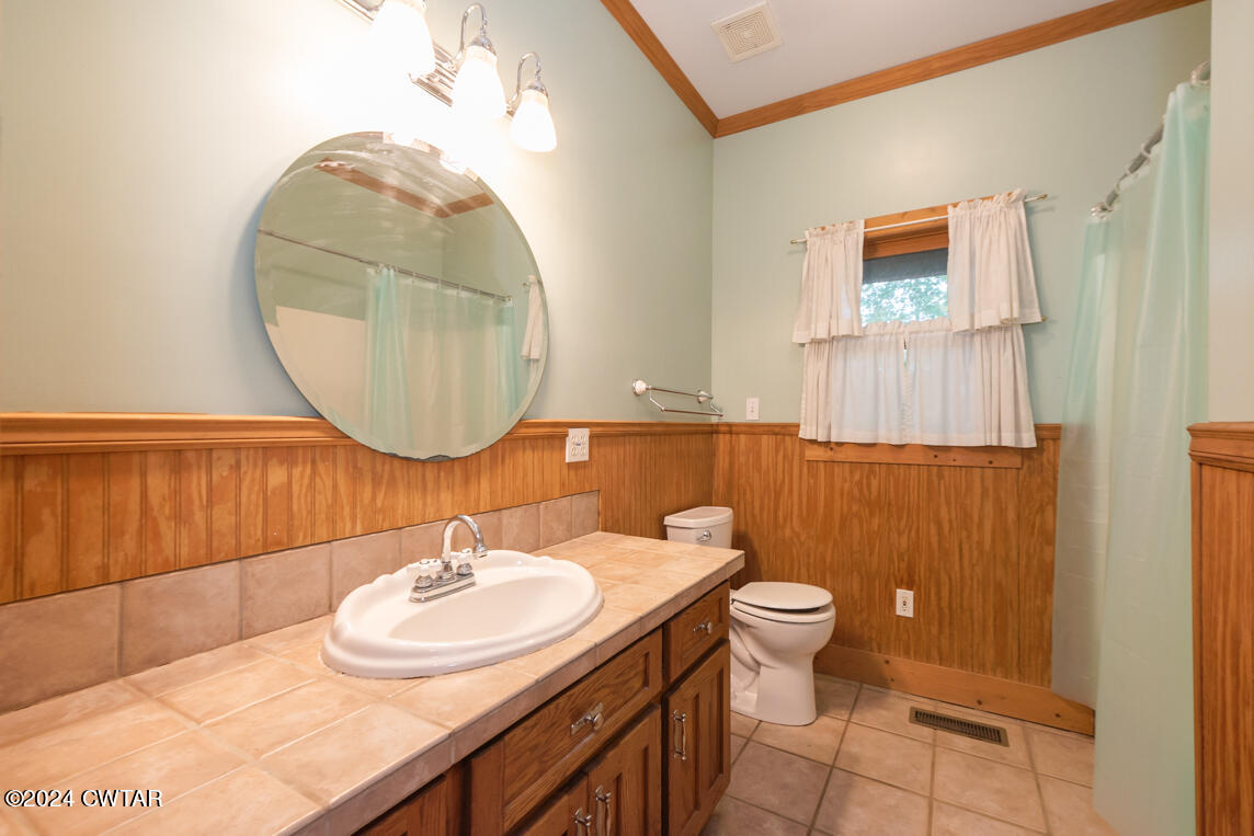 4392 Alberton Road Lexington, TN 38351 - Photo 25 of 75 a bathroom with a sink a toilet and a mirror