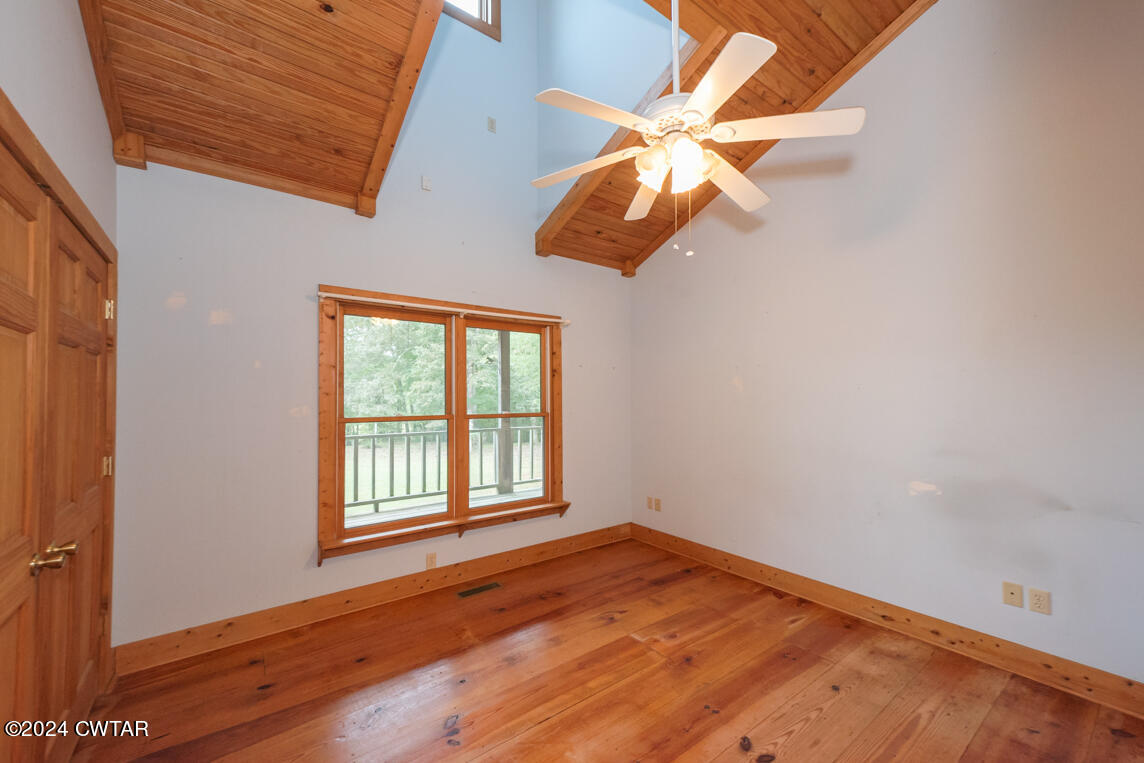 4392 Alberton Road Lexington, TN 38351 - Photo 27 of 75 an empty room with wooden floor fan and windows