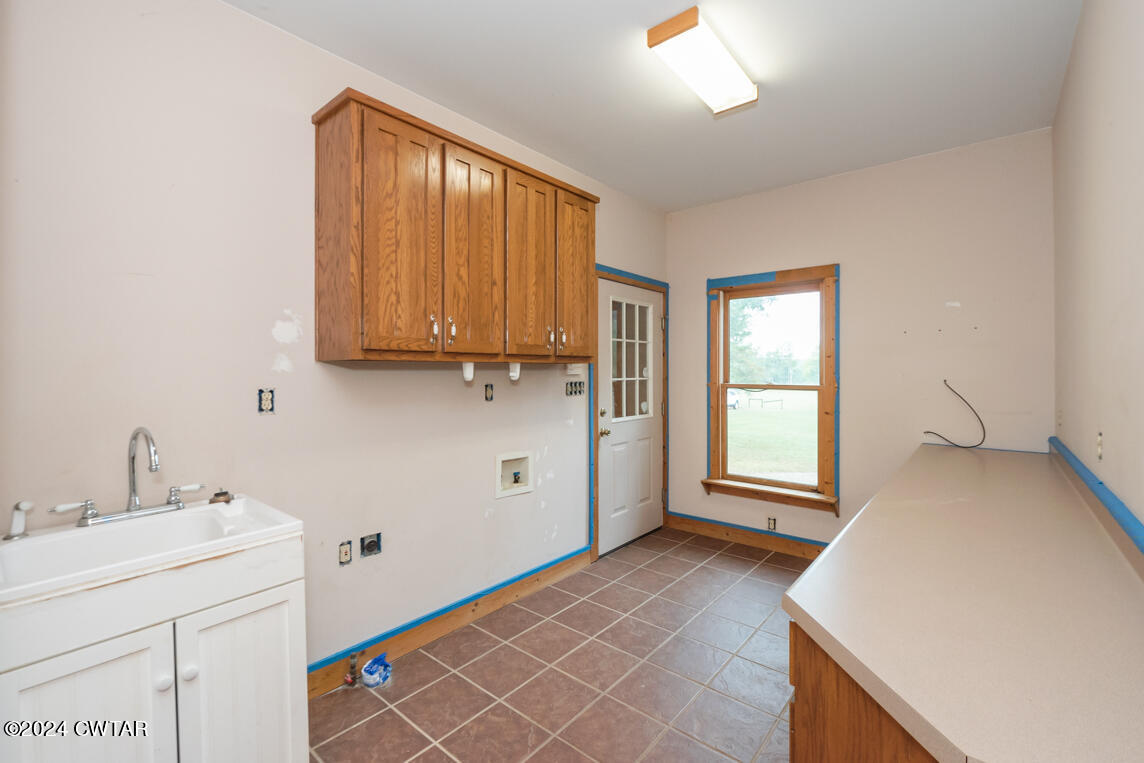 4392 Alberton Road Lexington, TN 38351 - Photo 28 of 75 a view of a kitchen with a sink dishwasher and a microwave oven