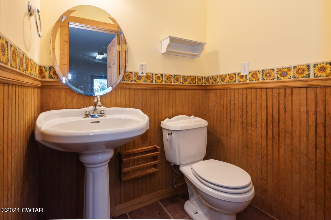 4392 Alberton Road Lexington, TN 38351 - Photo 30 of 75 a bathroom with a sink a toilet and a mirror