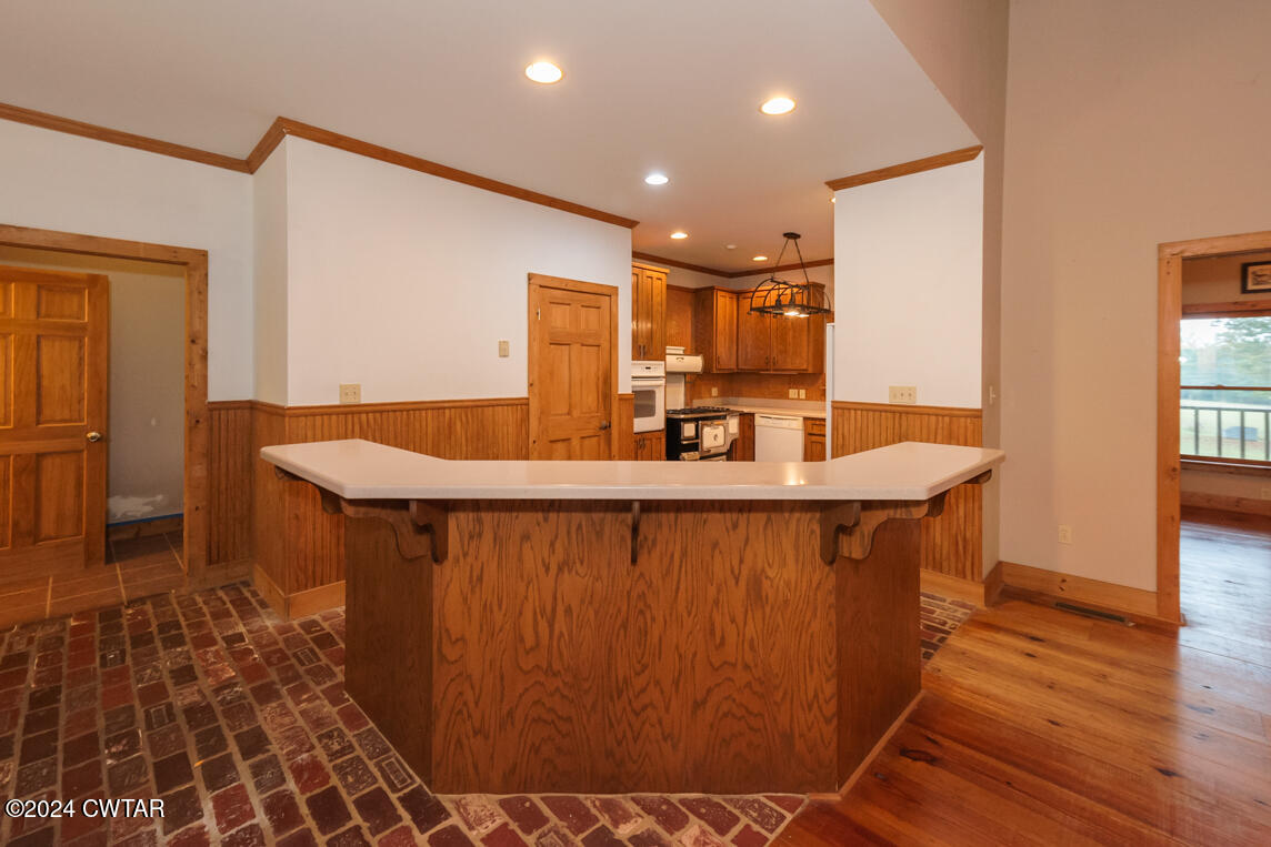 4392 Alberton Road Lexington, TN 38351 - Photo 44 of 75 a room with stainless steel appliances a sink cabinets and wooden floor
