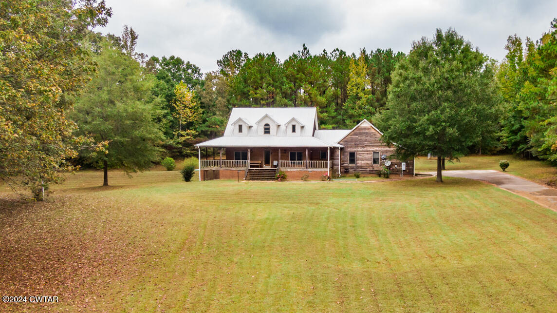 4392 Alberton Road Lexington, TN 38351 - Photo 54 of 75 a front view of a house with a big yard and large trees
