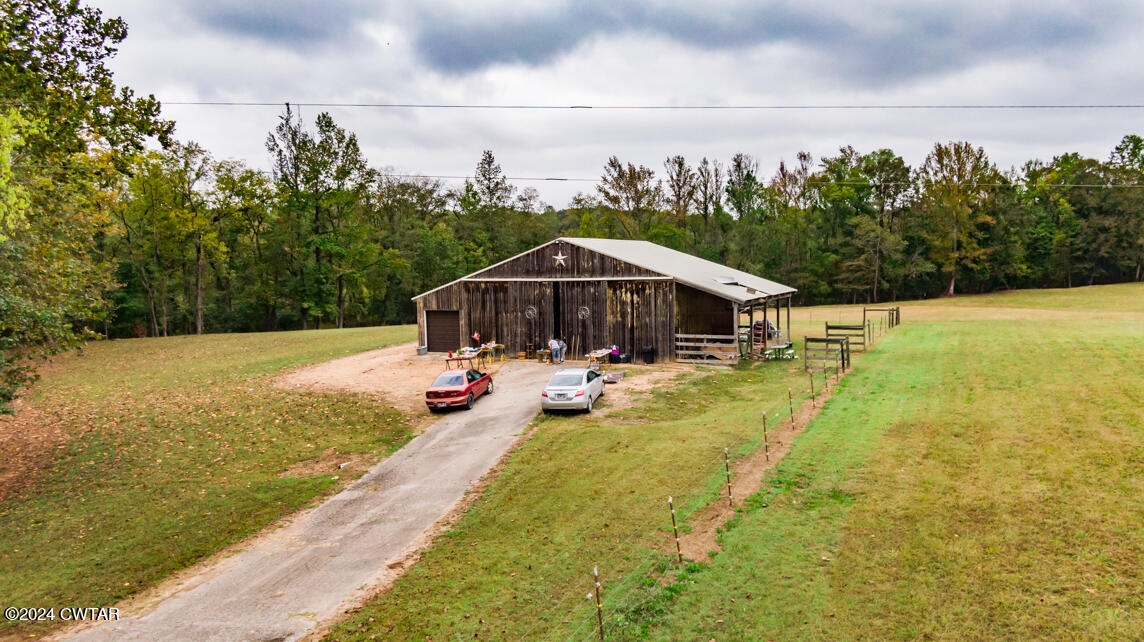 4392 Alberton Road Lexington, TN 38351 - Photo 58 of 75 a view of swimming pool with seating area and trees in the background