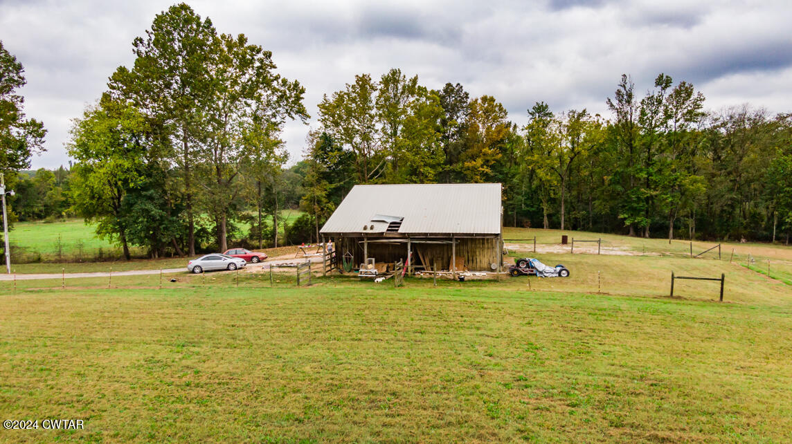 4392 Alberton Road Lexington, TN 38351 - Photo 61 of 75 a view of a swimming pool with lawn chairs and plants