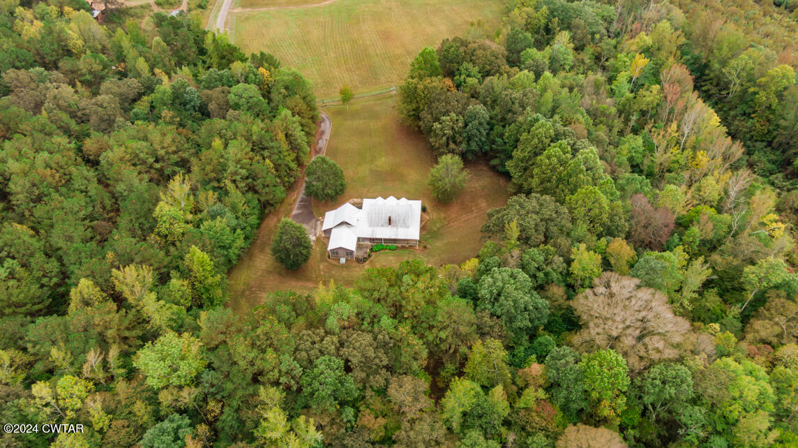 4392 Alberton Road Lexington, TN 38351 - Photo 74 of 75 an aerial view of residential house with outdoor space and trees all around