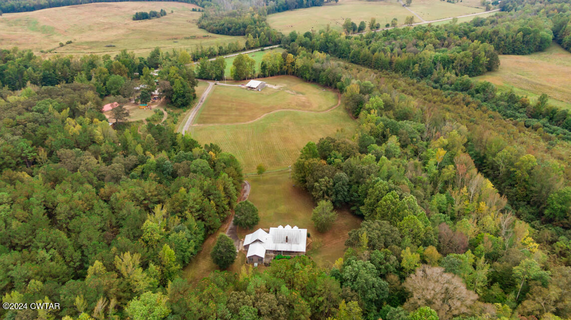 4392 Alberton Road Lexington, TN 38351 - Photo 75 of 75 an aerial view of a house with a yard and lake view