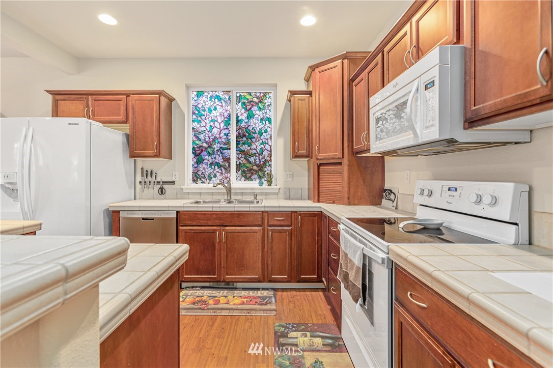 4313 147th Place Southeast Bothell, WA 98012 - Photo 14 of 29 a kitchen with stainless steel appliances granite countertop a stove and a sink