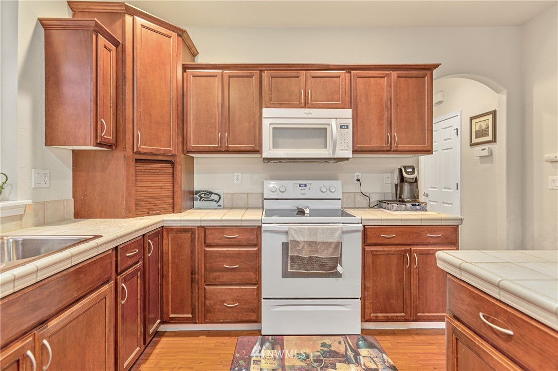 4313 147th Place Southeast Bothell, WA 98012 - Photo 15 of 29 a kitchen with a sink stove and cabinets