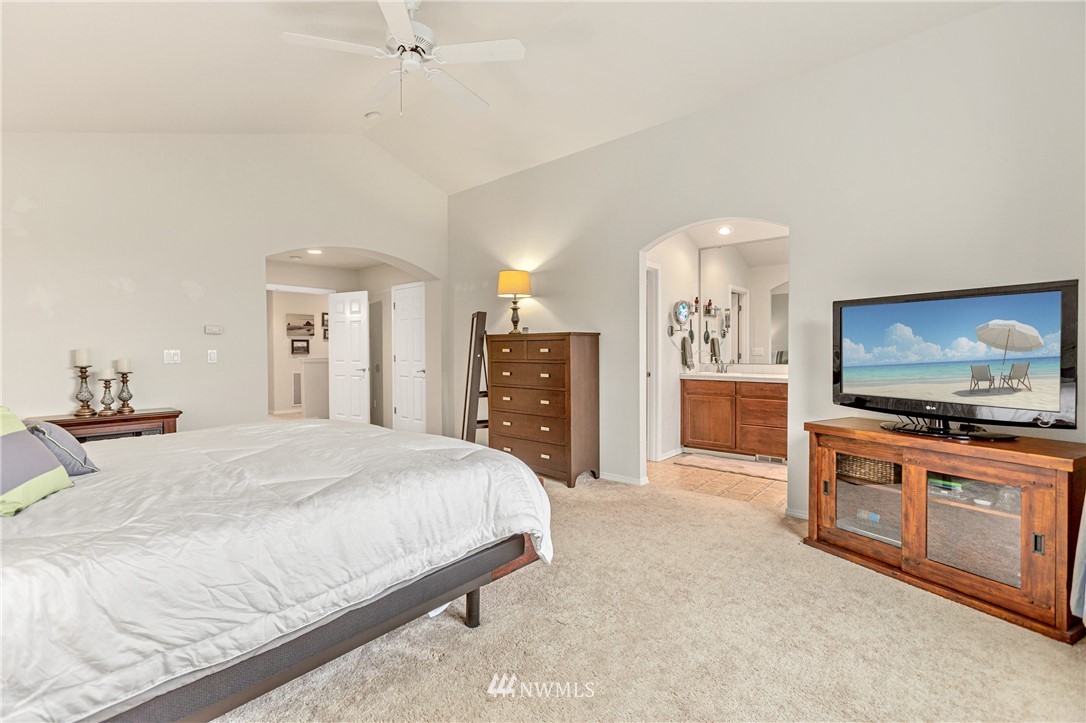 4313 147th Place Southeast Bothell, WA 98012 - Photo 17 of 29 a large bedroom with a bed and a flat screen tv