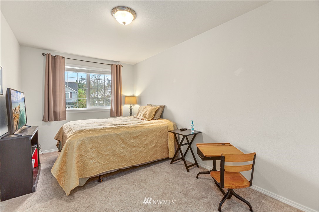 4313 147th Place Southeast Bothell, WA 98012 - Photo 22 of 29 a bedroom with a bed chair and a window
