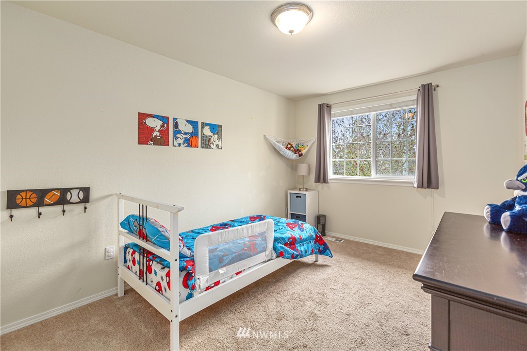 4313 147th Place Southeast Bothell, WA 98012 - Photo 23 of 29 a white bed sitting in a bedroom next to a window