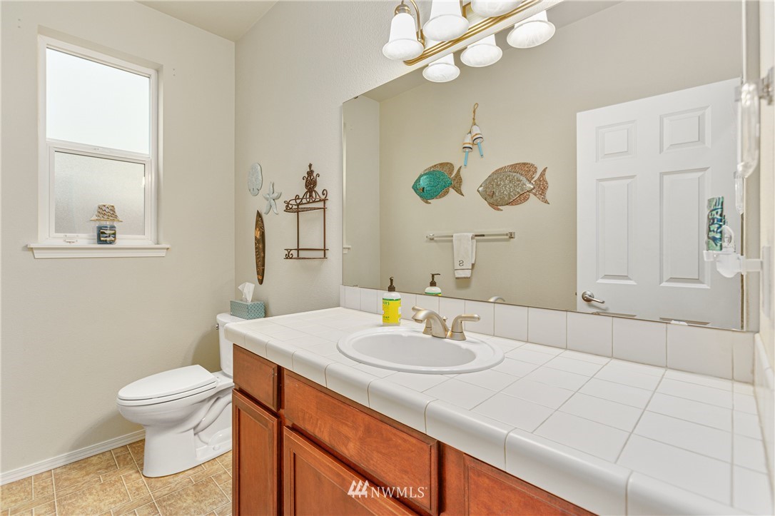 4313 147th Place Southeast Bothell, WA 98012 - Photo 24 of 29 a bathroom with a sink a toilet and mirror