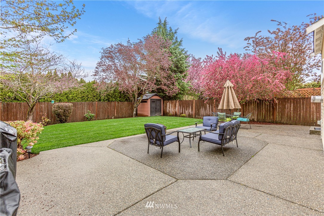 4313 147th Place Southeast Bothell, WA 98012 - Photo 27 of 29 a view of a patio with table and chairs with wooden fence