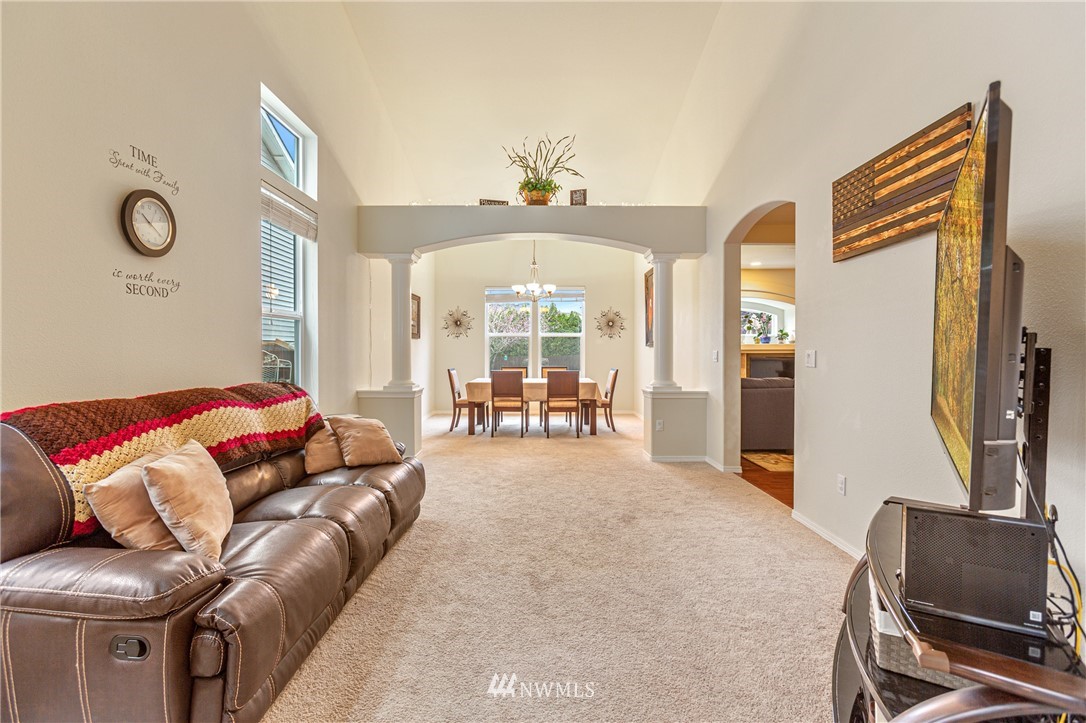 4313 147th Place Southeast Bothell, WA 98012 - Photo 8 of 29 a living room with furniture and a chandelier