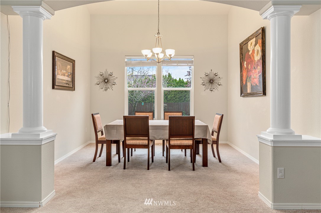 4313 147th Place Southeast Bothell, WA 98012 - Photo 9 of 29 a view of a dining room with furniture a chandelier and a window