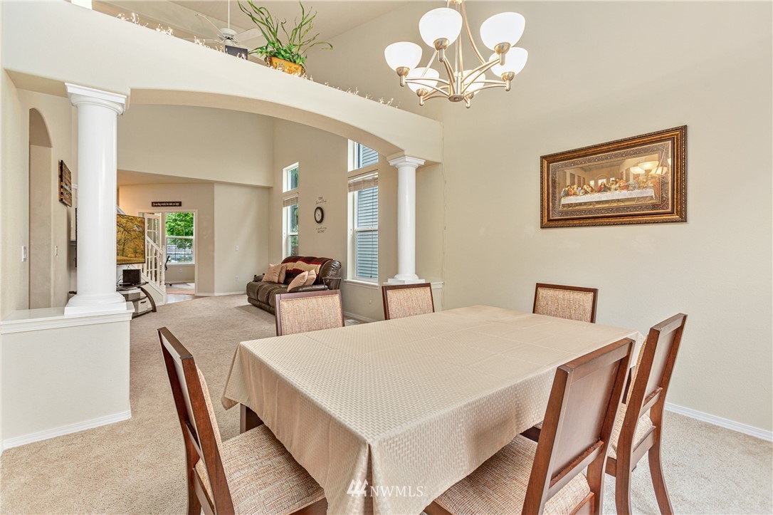 4313 147th Place Southeast Bothell, WA 98012 - Photo 10 of 29 a view of a dining room with furniture and chandelier