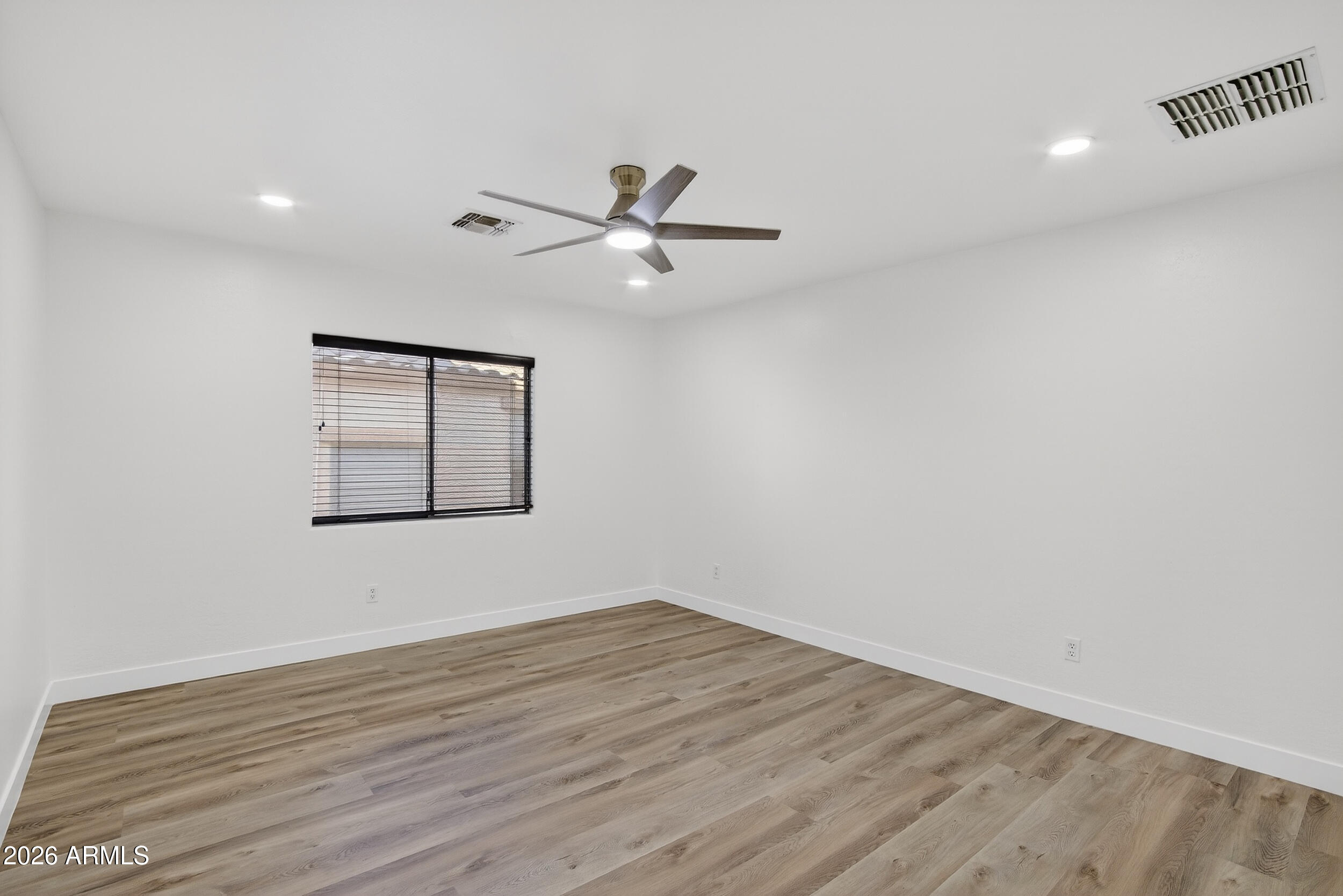 43620 West Cowpath Road Maricopa, AZ 85138 - Photo 45 of 60 wooden floor in an empty room with a window