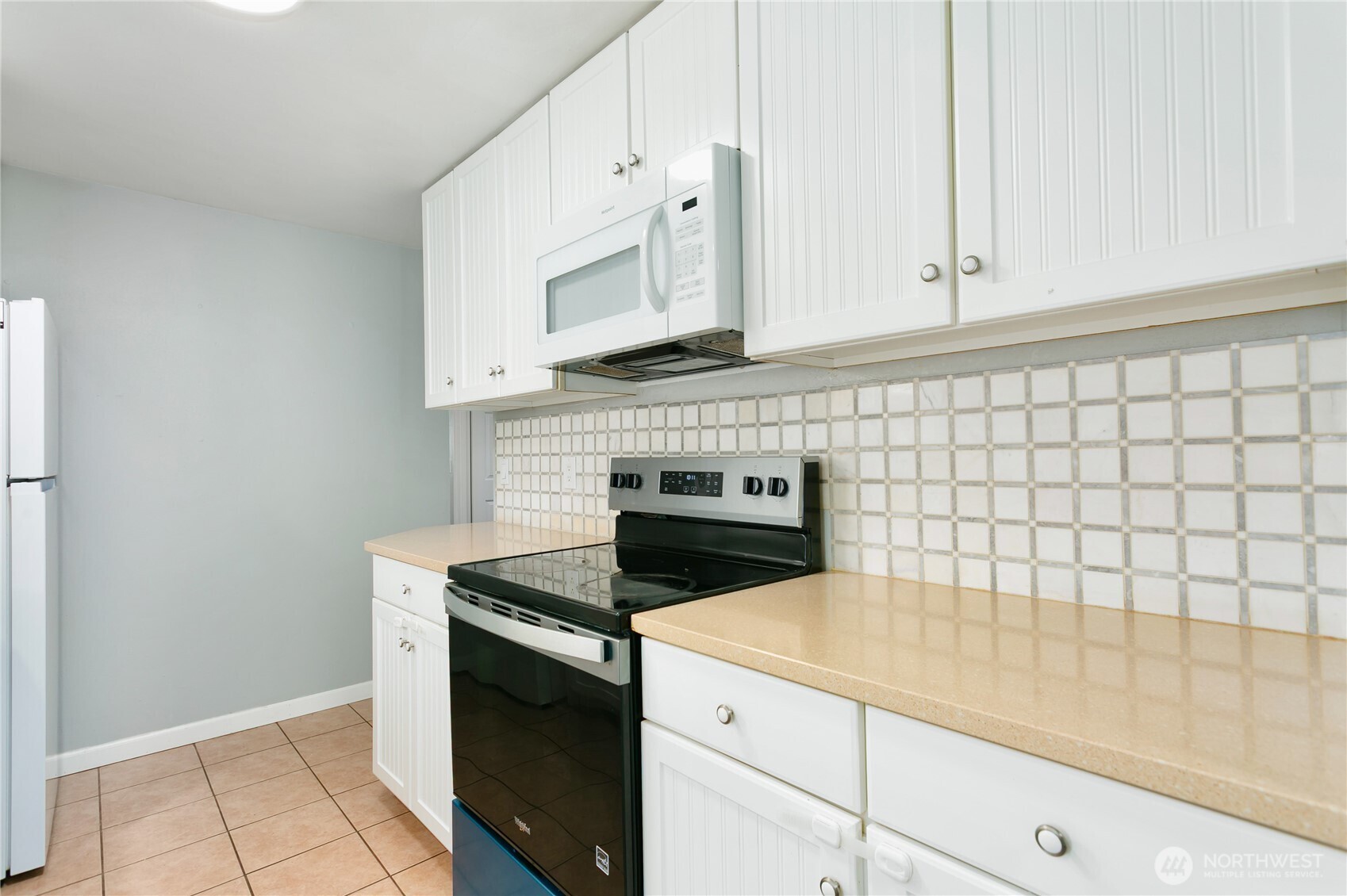 31327 12th Place South Federal Way, WA 98003 - Photo 11 of 40 a kitchen with white cabinets and a stove