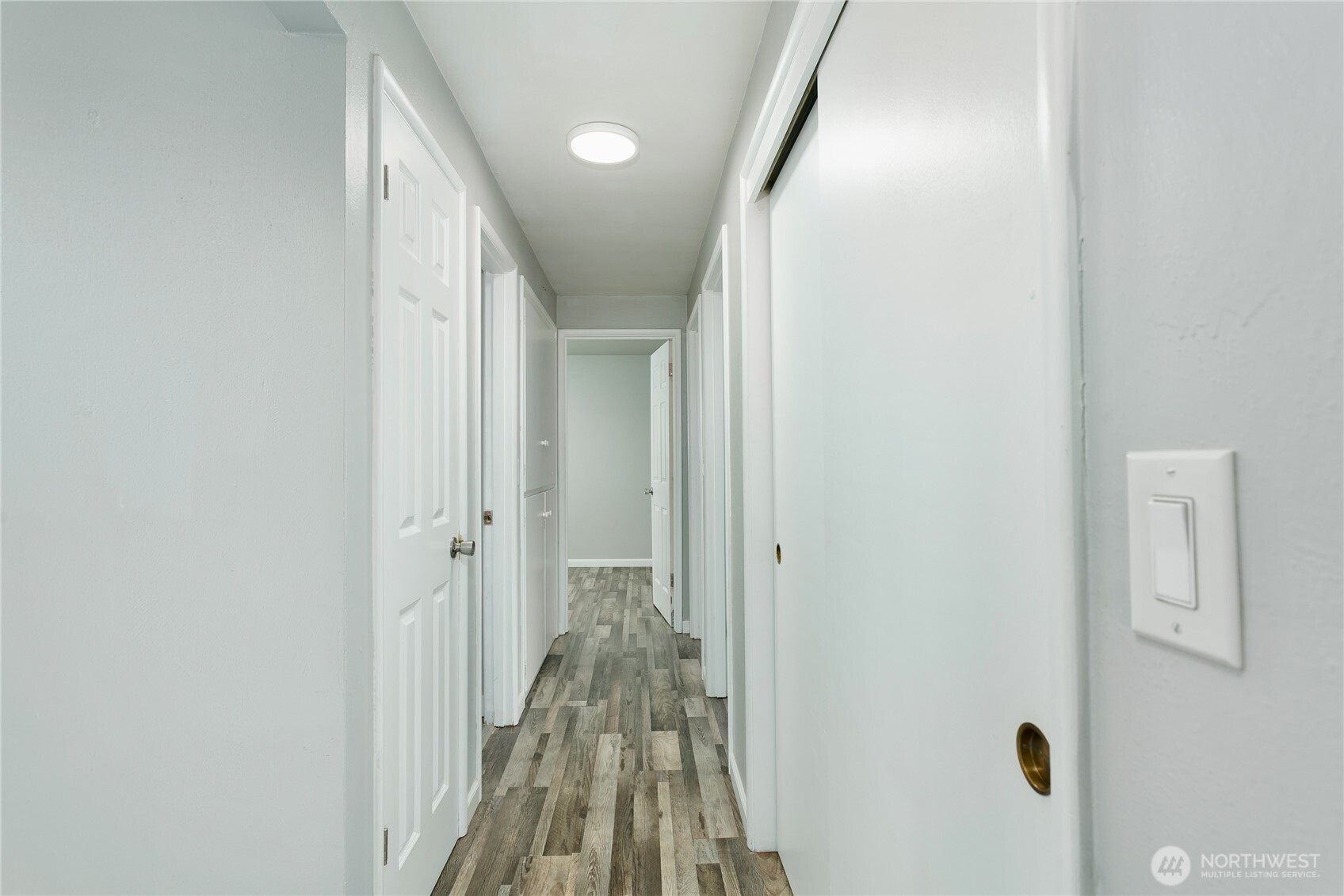 31327 12th Place South Federal Way, WA 98003 - Photo 14 of 40 a view of a hallway with a white door and a wooden floor