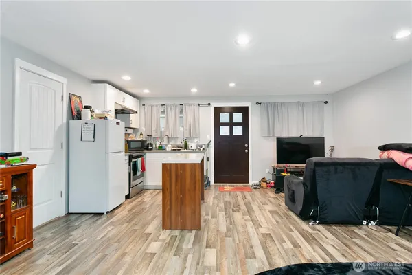 a view of kitchen with refrigerator microwave and cabinets