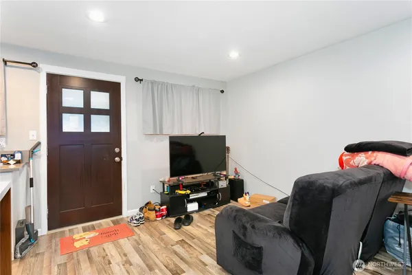 a bedroom with furniture and a flat screen tv