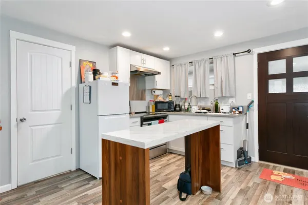 a kitchen with stainless steel appliances a refrigerator and a stove