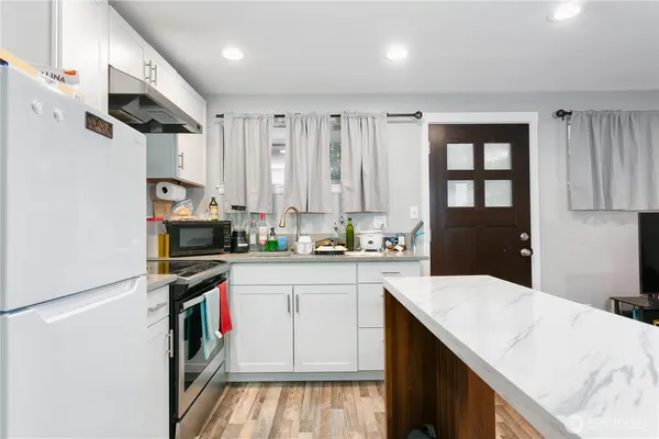 a kitchen with a sink appliances and cabinets