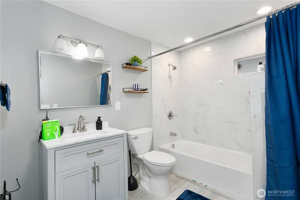 a bathroom with a sink toilet vanity and bathtub
