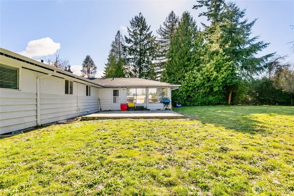 a front view of house with yard and swimming pool