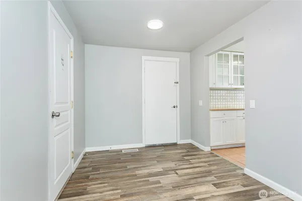 a view of a room with wooden floor and bathroom
