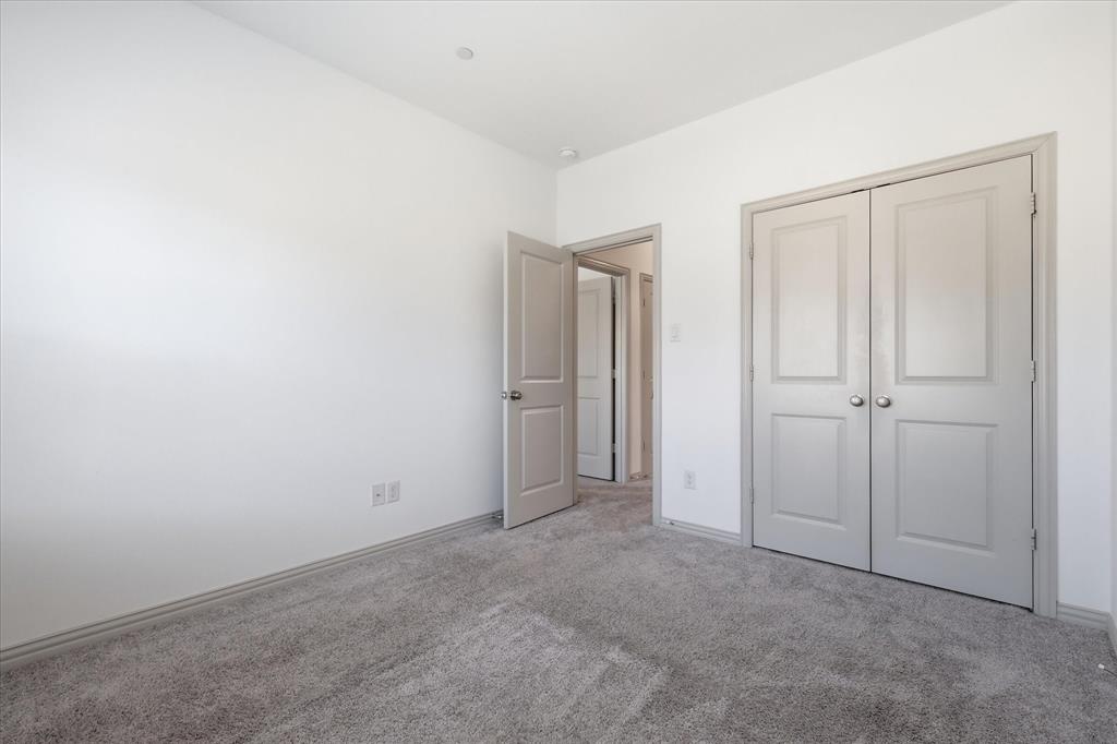 6141 Roper Road McKinney, TX 75070 - Photo 26 of 35 Neutral-toned carpeting complements the light wall paint and gray trim