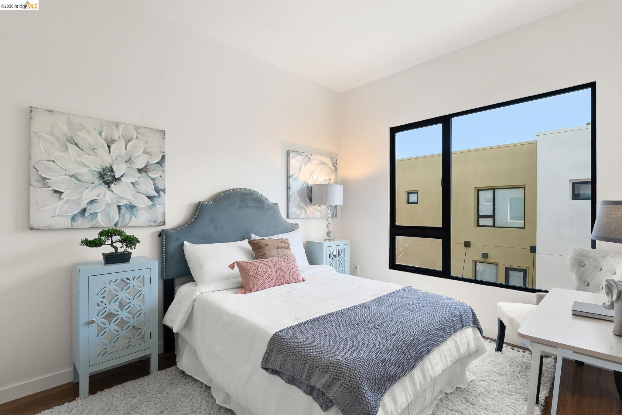 1780 12th Street Oakland, CA 94607 - Photo 18 of 31 a bedroom with a bed and a painting on the wall