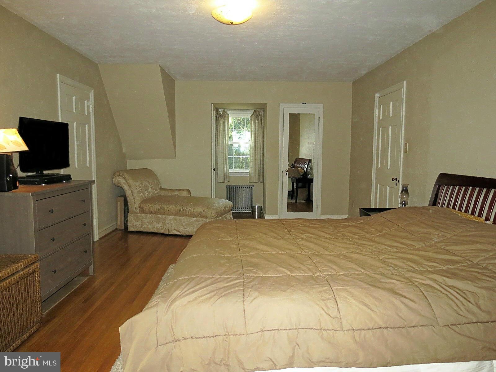 502 North Main Street Mount Airy, MD 21771 - Photo 19 of 27 a bedroom with a bed and flat screen tv